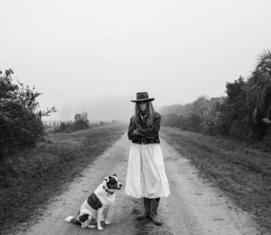 Fine art photographer and Campo Garzon founder on a country road with her dog